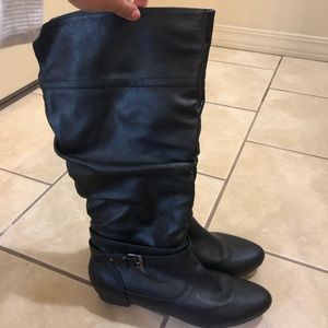 Tall black leather boots with buckle